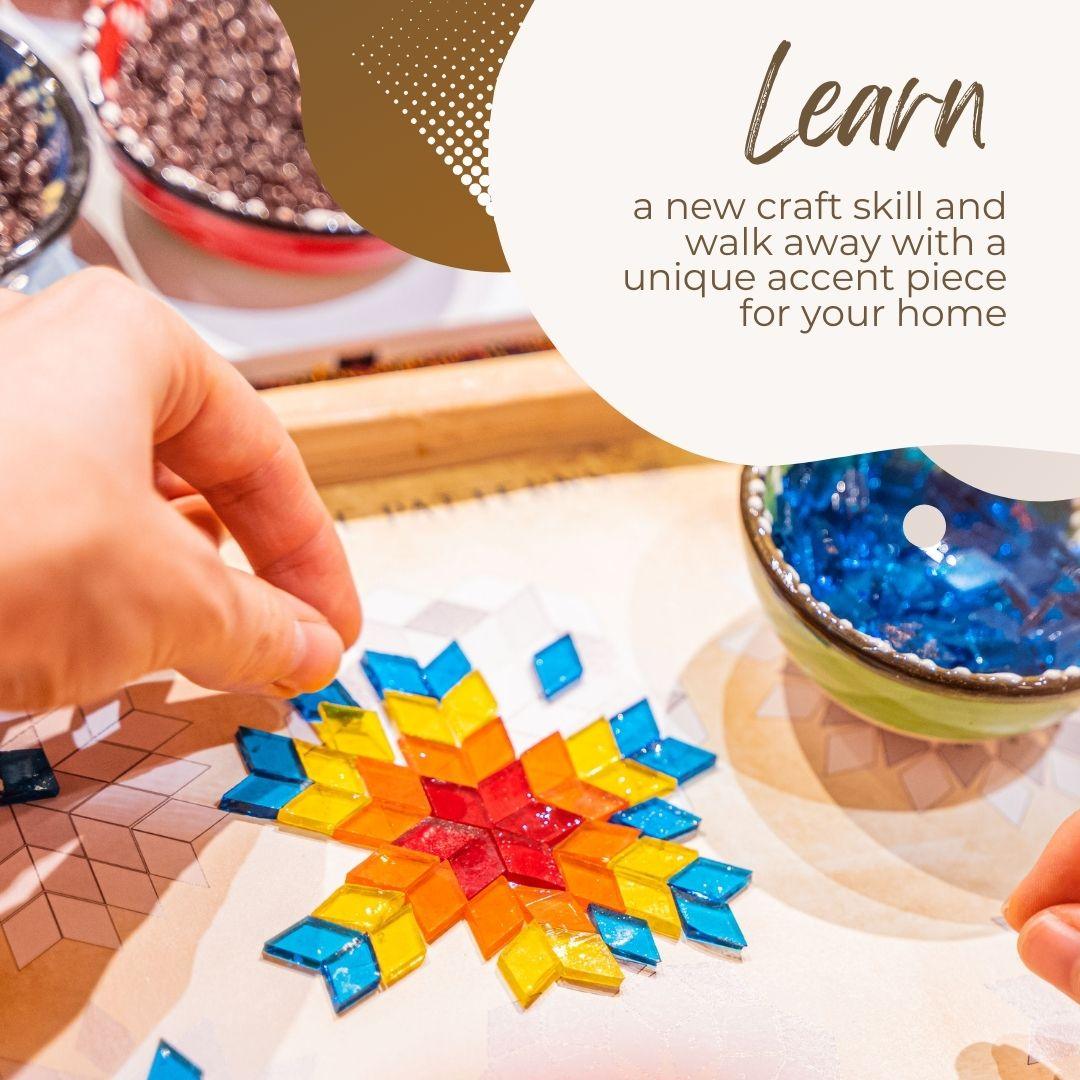 Handcrafting a colorful star-shaped design with mosaic tiles on a table.